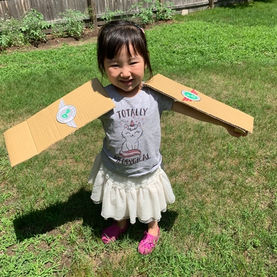 customer photo of Beanstalk.co Posing with her cardboard arms like an airplane wing!